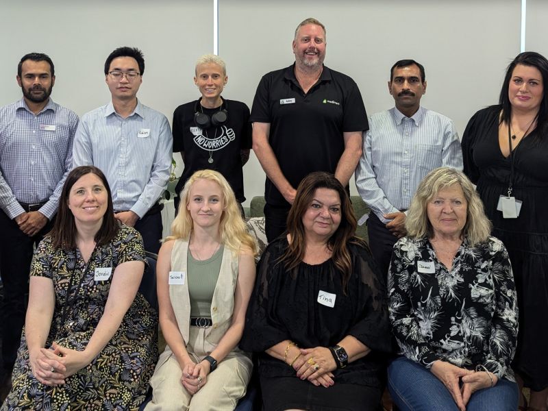 Photograph of the 12 members of the City of West Torrens Disability Inclusion Advisory Group sitting, standing and looking at the camera.